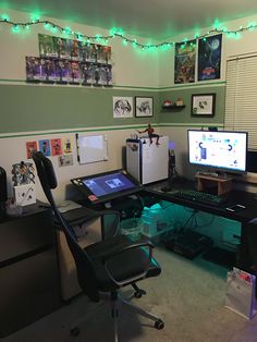 a desk with two monitors and a laptop on it in a room filled with pictures