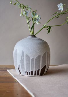 a vase with flowers in it sitting on a table