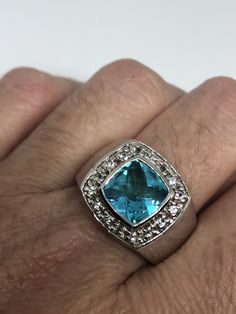 Huge great color blue topaz stone Genuine white sapphires surrounding setting is handcrafted in 925 sterling silver Size 9 Can be sized, my jeweler charges $10-$20 Please ask for a quote? All rings are shipped free in the US in a nice gift box. Check out our over a THOUSAND great reviews Engraving is $4 per letter and is not always perfect depending on the piece. It can take a few days if the jeweler is busy. This is payable to Paypal Judithsltd@gmail.com Turquoise Topaz Diamond Ring For Anniversary, Anniversary Turquoise Topaz Ring With Diamond, Blue Gemstone Jewelry With White Topaz, Blue White Topaz Ring, Blue White Topaz Jewelry With Accent Stones, Anniversary Turquoise Topaz Ring Stamped 925, Blue White Topaz Ring For Anniversary, Anniversary Blue White Topaz Ring, Blue Topaz Stone