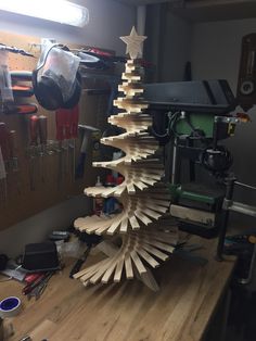 a christmas tree made out of wooden planks on top of a table in a room