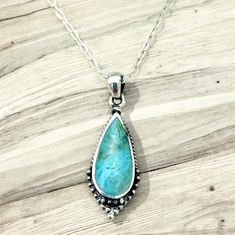 Discover the perfect blend of sophistication and bohemian charm with our Sterling Silver Turquoise Teardrop Pendant--a piece destined to become the centerpiece of your jewelry collection. Handcrafted with meticulous attention to detail, this pendant features a vibrant turquoise stone, renowned for its deep connection to tranquility and protection. Encased in a sterling silver teardrop frame, the gemstone exudes a serene beauty that captivates the eye and soothes the soul. Let this exquisite pendant be a testament to your refined taste and a reflection of your inner grace. With its enchanting color and timeless design, the Sterling Silver Turquoise Teardrop Pendant is more than just an accessory; it's a keepsake to be cherished for years to come. Measuring approximately 0.45 inches in width Bohemian Sterling Silver Teardrop Pendant Necklaces, Bohemian Sterling Silver Pendant Drop Necklace, Bohemian Sterling Silver Teardrop Pendant Necklace, Turquoise Drop Bohemian Jewelry, Turquoise Bohemian Drop Jewelry, Bohemian Turquoise Drop Jewelry, Bohemian Teardrop Sterling Silver Drop Necklace, Bohemian Turquoise Teardrop Pendant Necklace For Gift, Spiritual Turquoise Teardrop Necklaces