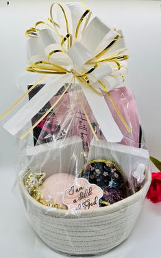 This is a one-of-a-kind Christian gift basket for women. \nIncludes the following:⭐ "More Than a Conqueror" engraved adjustable cord bracelet in black.⭐ Mustard seed keychain⭐ Jesus pink canvas makeup bag⭐ Black and pink floral compact mirror⭐ Lavender scented candle⭐ Pink Champagne bath bomb⭐ Anointing oil with Frankincense, Myrrh, and Spikenard⭐ Proverbs 31:25 lined journalThank you for visiting Chosen By His Grace ❤️ Christian Gift Baskets, More Than A Conqueror, Gift Basket For Women, Womens Bible, Adjustable Cord Bracelet, Bible Study Gifts, Black Mustard Seeds, Lavender Scented Candle, Church Gifts