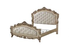 an antique style bed with white upholstered headboard and foot board, made from wood