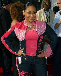 a woman standing on a red carpet with her hands on her hips