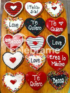 heart shaped cookies are arranged on a wooden board with words written in spanish and english