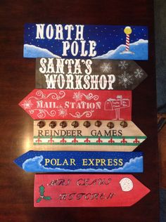 the north pole santa's workshop sign is made out of wood and has different types of signs on it