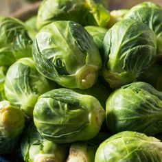 brussel sprouts piled on top of each other in a blue bowl