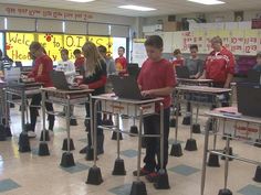 a group of people working on laptops in a classroom