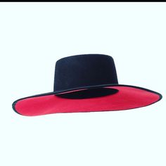 Black wide brim, red bottom hat. Quality soft wool touch and the essential statement piece that your outfit needs. One size fits all. Classic Red Fedora With Wide Brim, Classic Red Wide Brim Fedora, Classic Red Brimmed Felt Hat, Fitted Red Felt Hat With Flat Brim, Classic Red Wide Brim Top Hat, Wide Brim Fedora For Evening In Fall, Elegant Red Fedora For Fall, Red Formal Fedora Felt Hat, Elegant Red Adjustable Felt Hat