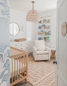 a baby's room with a crib, rocking chair and pictures on the wall