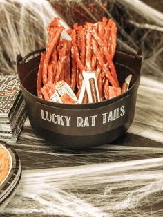 there is a bowl full of lucky rattails on the table next to some plates