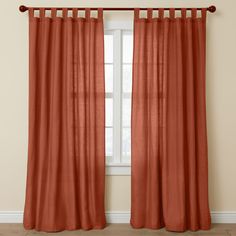 an orange curtain hanging in front of a window