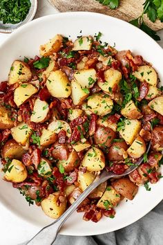 a white bowl filled with potatoes and bacon