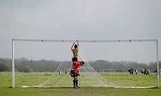 two men are playing soccer on the field