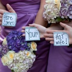 the bridesmaids are holding their bouquets with signs that read, we're married