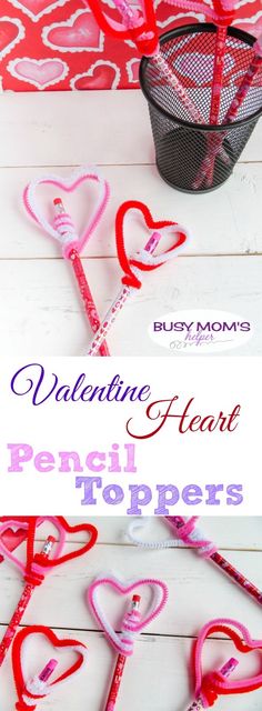 valentine's heart pencil toppers on a white table with pink and red hearts