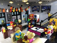 legos are arranged in the shape of people sitting at a table and playing video games