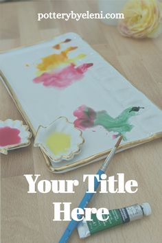 a wooden table topped with paint and flowers