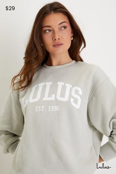 If you love Lulus, then you are definitely going to love the Lulus Anniversary Sage Green Crew Neck Graphic Pullover Sweatshirt to celebrate our birthday! This stretchy cotton-blend knit sweatshirt (with a soft fleece reverse) will be your new go-to thanks to its classic crew neck, long sleeves with drop shoulders and fitted cuffs, and a comfy oversized bodice. White graphic at the front reads ""Lulus Est. 1996"". Pair with the matching shorts for a complete look! Fit: This garment fits true to Green Crew Neck, Graphic Pullover, Our Birthday, Knit Sweatshirt, Pullover Sweatshirt, Sage Green, Bodice, Graphic Sweatshirt, Cotton Blend