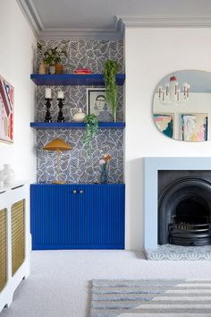 a living room filled with furniture and a fire place in front of a wall mounted mirror