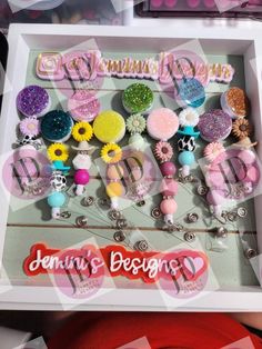 a box filled with lots of different types of hair clips and brooches on top of a table