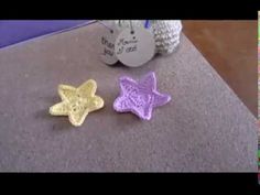 two crocheted stars sitting on top of a counter next to a stuffed animal