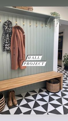 a wooden bench sitting in front of a coat rack