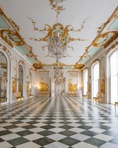 an ornately decorated room with chandeliers and mirrors on the walls, in gold and white