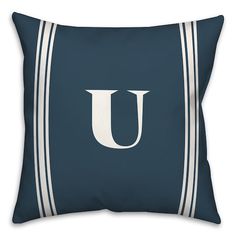 a blue pillow with a white letter j on the front and side stripes around it