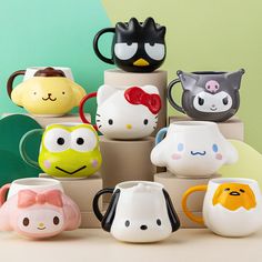 a stack of hello kitty mugs sitting on top of each other in front of a green wall