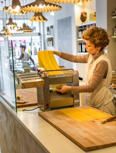 a woman working on a machine in a shop