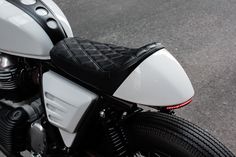 a white and black motorcycle parked on the street