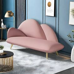 a living room with blue walls and pink furniture