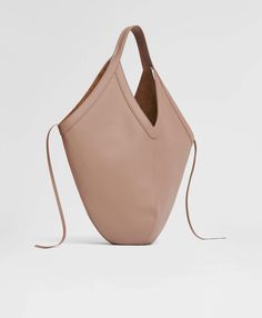 !!!Description---Our suede-lined Italian leather Soft M Hobo bag has an oversized, graphic shape designed to tote all your everyday belongings. For added versatility, four interior ties can be knotted to give the bag more structure or left open for a slouchier silhouette. !!!Fits---16" Laptop !!!Details---Width at base: 10.24 in / 26 cmWidth at Top: 20 in / 51 cmHeight: 12.6 in / 32 cmDepth: 0.79 in / 2 cmHandle Drop: 12.2 in / 31 cm Composition:Outer: 100% Italian Embossed Cow LeatherLining: 10 Graphic Shapes Design, Expensive Bag, Base 10, Handmade Beauty Products, Leather Conditioner, Monogrammed Items, Top 20, Vintage Shoes, Style Elegant