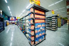 an empty grocery store aisle filled with lots of food