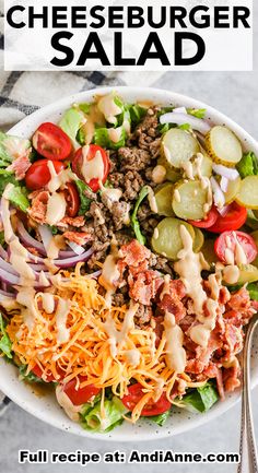 a white bowl filled with cheeseburger salad on top of a table next to a fork