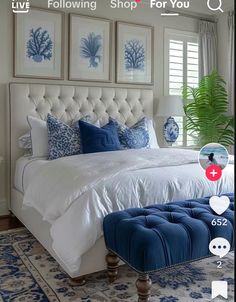 a bedroom with blue and white decor on the walls, along with pictures above the bed