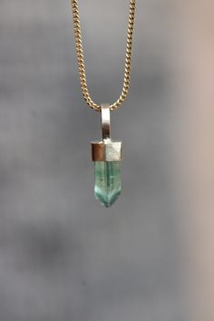 This beautiful pendant features a dainty green tourmaline from Afghanistan, weighing approximately 2.5 carats. The tourmaline displays a gorgeous mint green color and is set in a hand-filed, sparkling 14k yellow gold bezel cap and bale, adding a touch of elegance and sophistication. This pendant is perfect for layering or wearing on its own, making it a versatile addition to any jewelry collection. Please note that no chain is included in this listing. Details: *2.5ct mint green tourmaline from Everyday Tourmaline Gemstone Jewelry, Green Tourmaline Gemstone Necklace, Gold Tourmaline Pendant Jewelry, Elegant Tourmaline Pendant Jewelry, Bohemian Green Pendant Gemstones, Green Tourmaline Pendant Jewelry, Green Tourmaline Pendant, Mint Green Color, Tourmaline Pendant