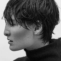 black and white photograph of a woman with wet hair looking off to the side in profile