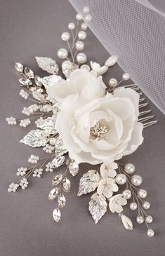 a bridal hair comb with white flowers and pearls