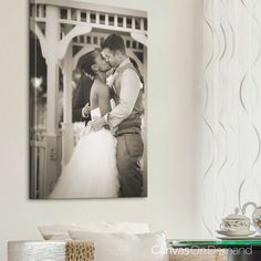 a black and white photo of a bride and groom kissing