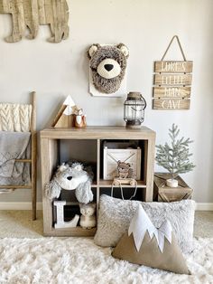 a teddy bear sitting on top of a wooden shelf next to pillows and other items