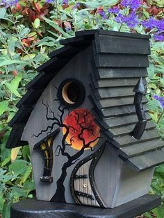 a bird house with a tree on the roof