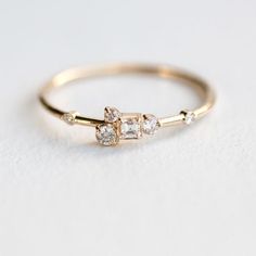 a gold ring with three diamonds on it