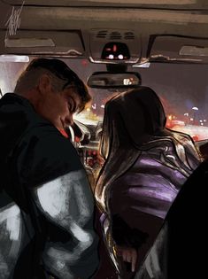 two people in the back seat of a car looking at something on the floor below them