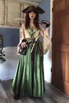 a woman dressed up as a pirate standing in a room with wooden floors and doors