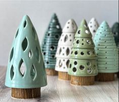 small ceramic trees sitting on top of a wooden table