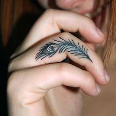 a woman's hand with a small feather tattoo on her left thumb and the words, 8 simple beauty