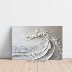 an abstract painting with white paint and waves in the background, on a wooden floor