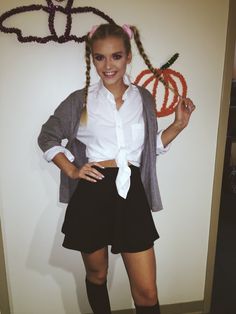 a young woman is dressed up as a girl with long braids and pigtails